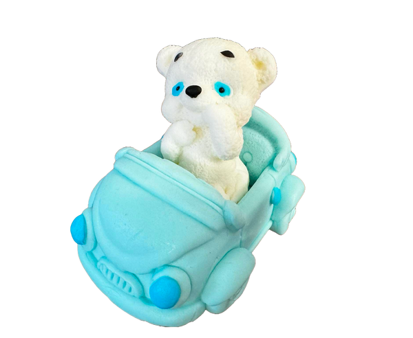 Edible decoration of sugar paste, white teddy bear with a blue car